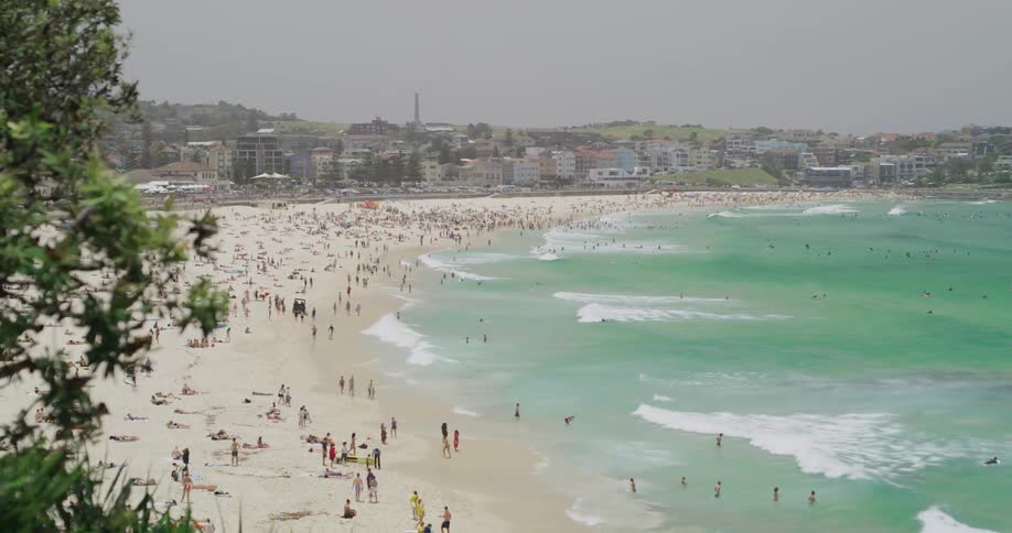 Beach goers swarm the beach near town