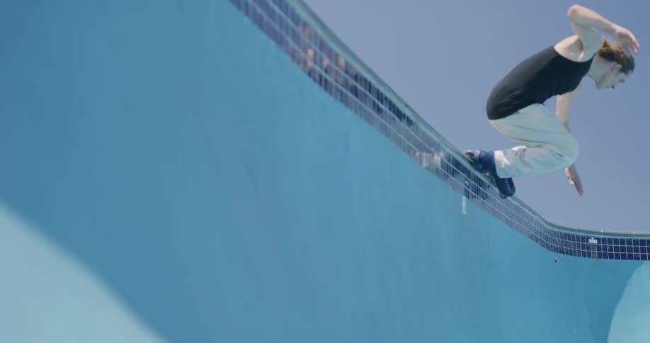 A man is rollerblading in the swimming pool