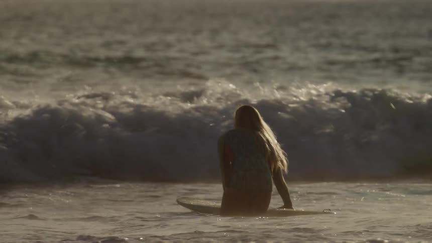 A woman surfing in the ocean