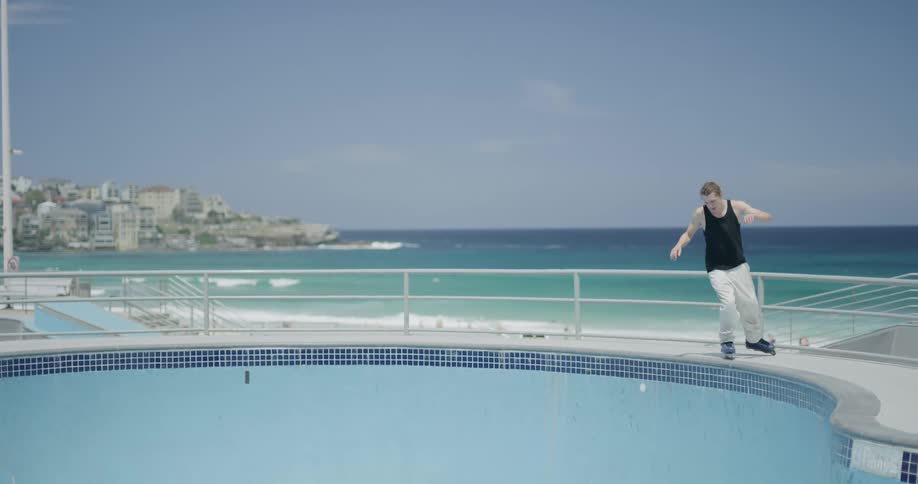 A man skates down the pool