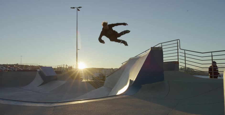Rollerblader gets air on a quarter pipe