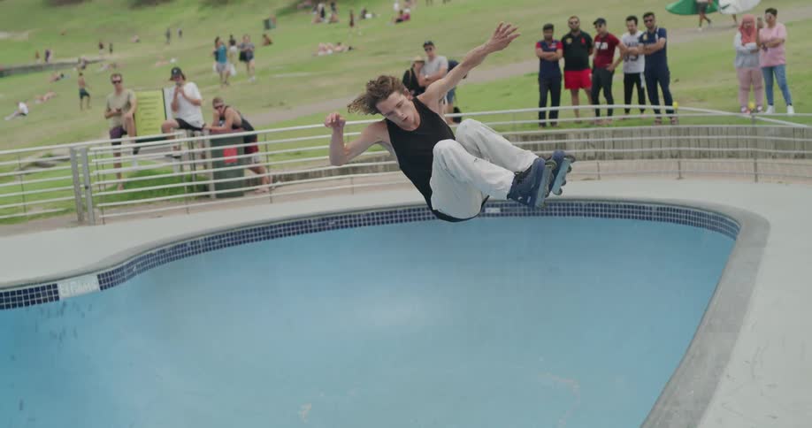 The man skates in the pool
