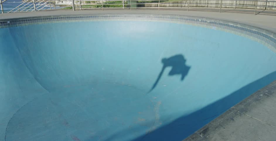 A person skates in the skate park
