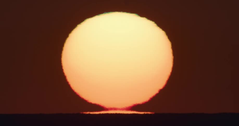 The sun rises in the sky