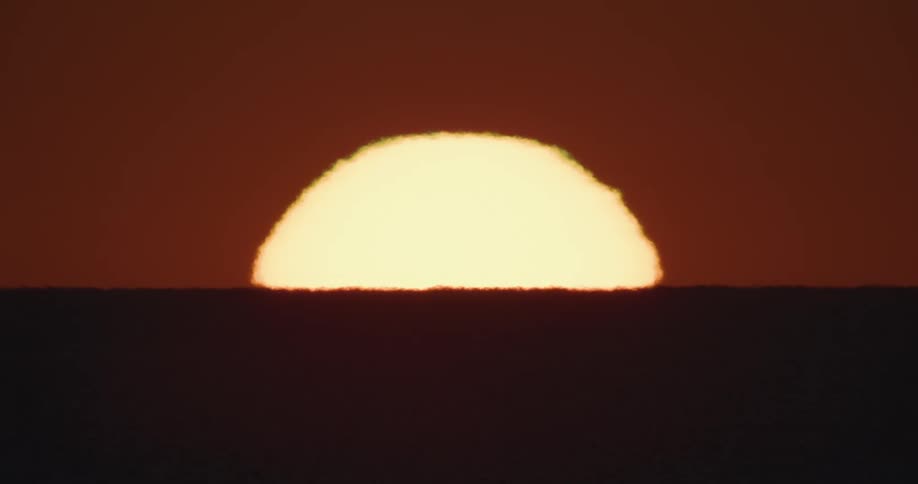 Sun rises turning landscape into oranges and browns