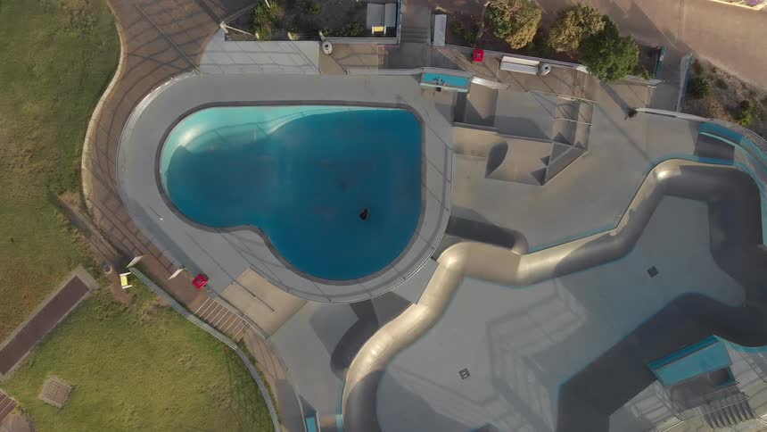 Birds eye view of a person skating and another jogging