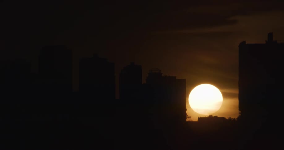 Silhouette of buildings with the sunset in the background