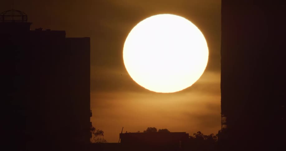 Silhouette of buildings with the sunset in the background