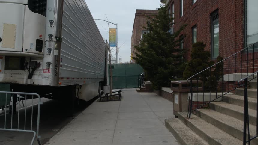 A morgue truck sits on a Brooklyn street