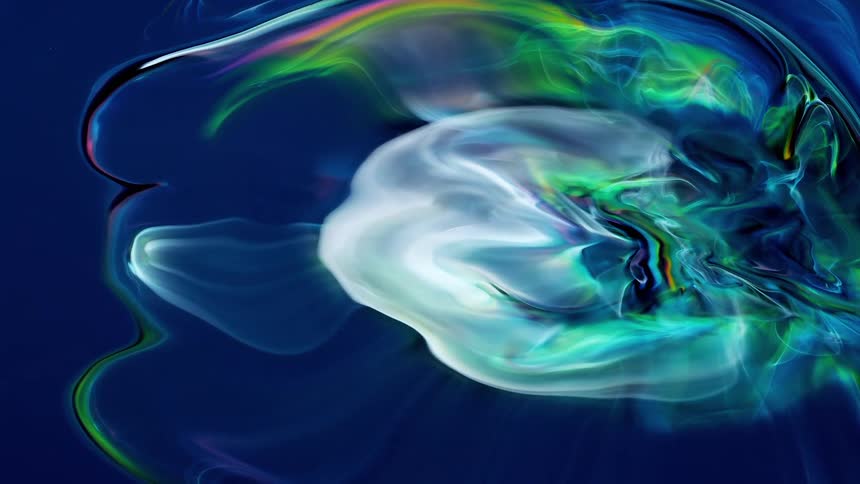 A green and white cloud expands on a dark blue background