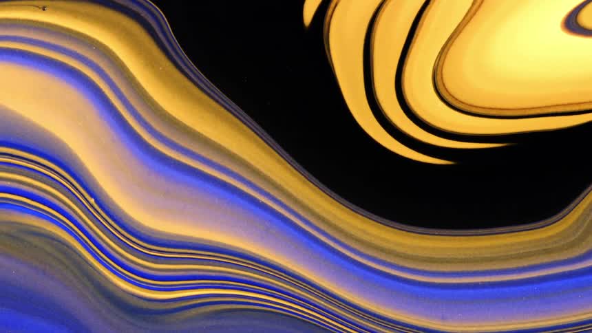 A close up of curved and marbled shapes of color in blue and orange