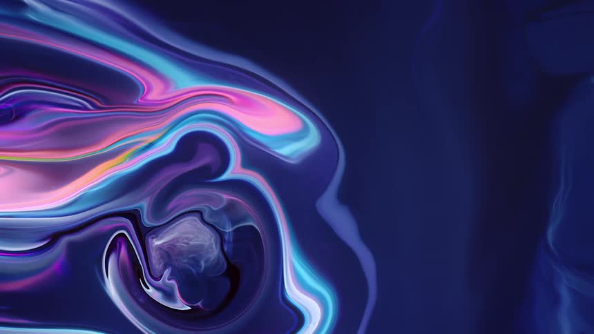 Colorful waves of pink ink float on liquid blue surface
