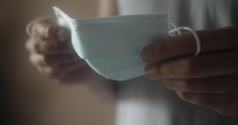 A person holds a medical mask