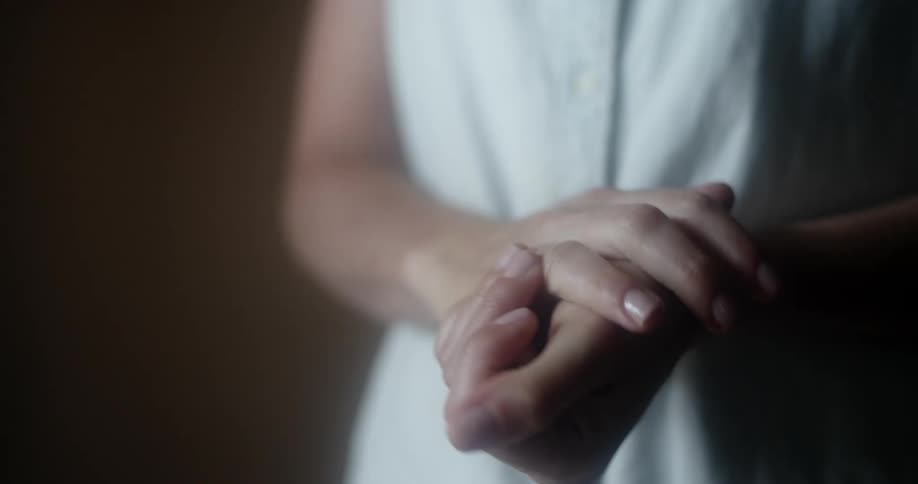 Person pours hand sanitizer on hands then rubs them together