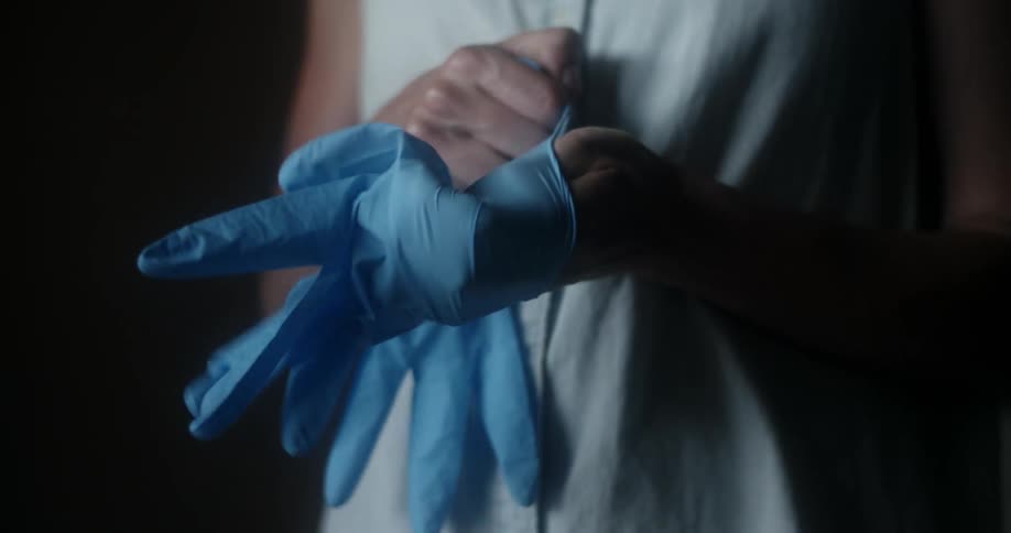 Person puts on medical gloves