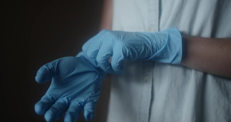 A person pulling latex gloves tight on their hands