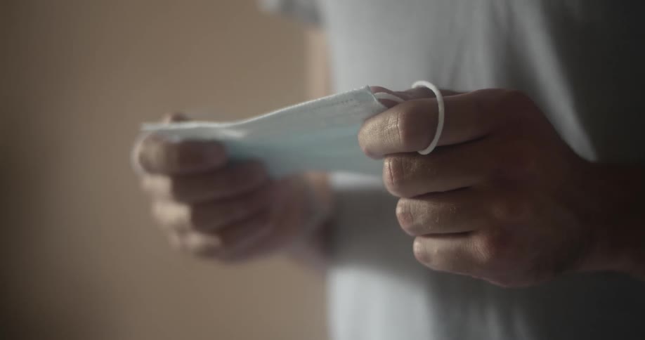 A person holds a surgical mask