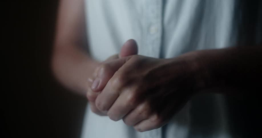 A woman applies hand sanitizer and rubs her hands together