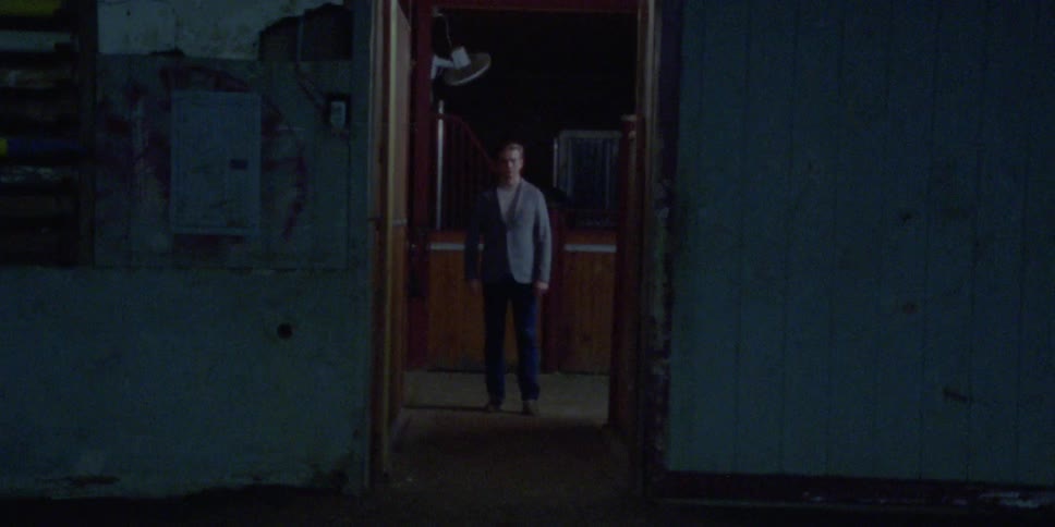 A man walks into a room then aggressively walks out
