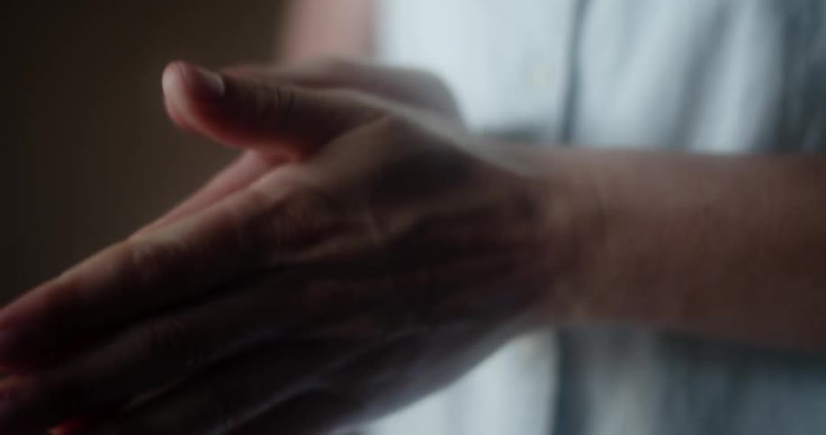 A person spraying hand sanitizer in their palms and rubbing it in