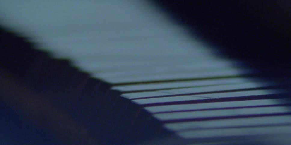 Piano keys are shown up close as they are played