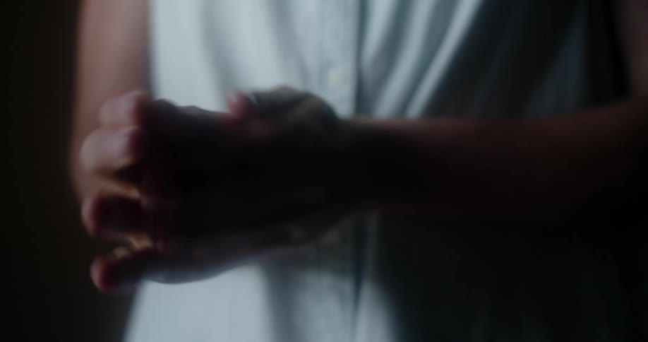 A woman applies a pump of hand sanitizer to her hands and rubs her hands together