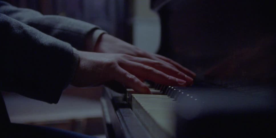 A pair of hands playing the piano
