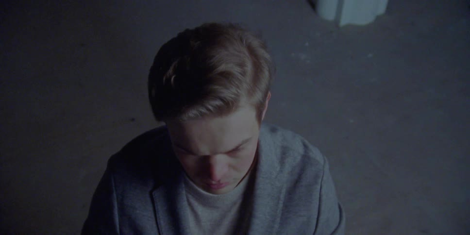 A man at a piano stretches his hands above his head and stretches his fingers before playing