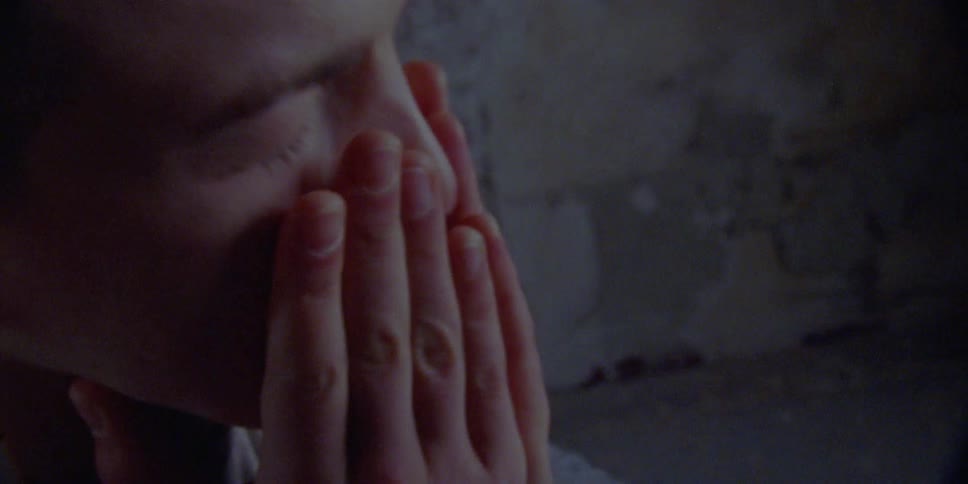 A person rubs their face