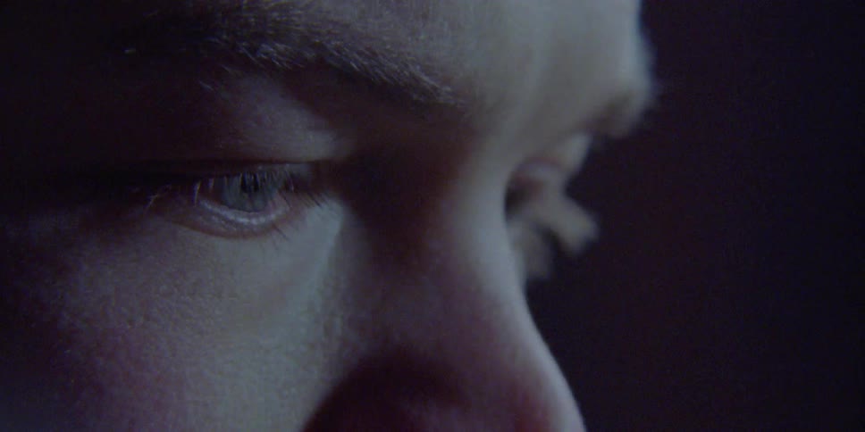 Man opens and closes his eyes in the dark background
