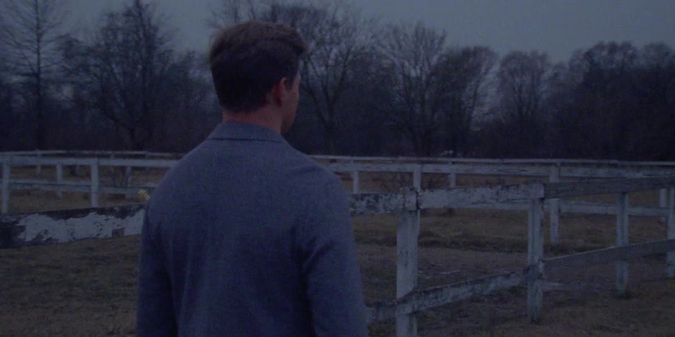 The man walks near the fence