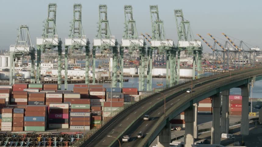 The cars travel over the bridge