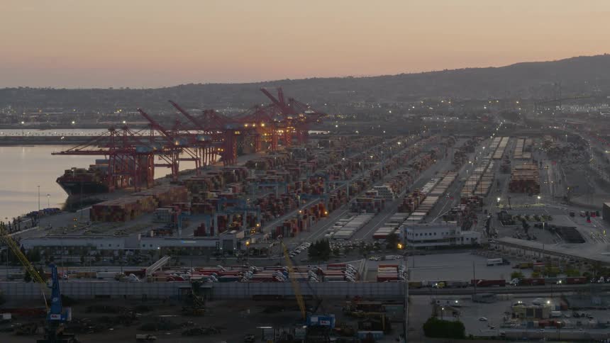 A shipping dock with trucks and cranes