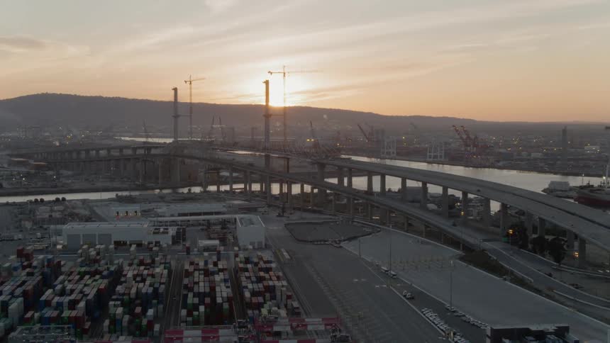 A bridge stretches over a body of water near a city