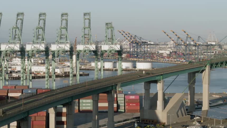 Aerial shot of a shipping dock with a large bridge