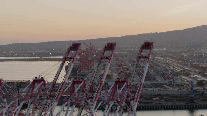 A shipyard next to a busy road in the evening