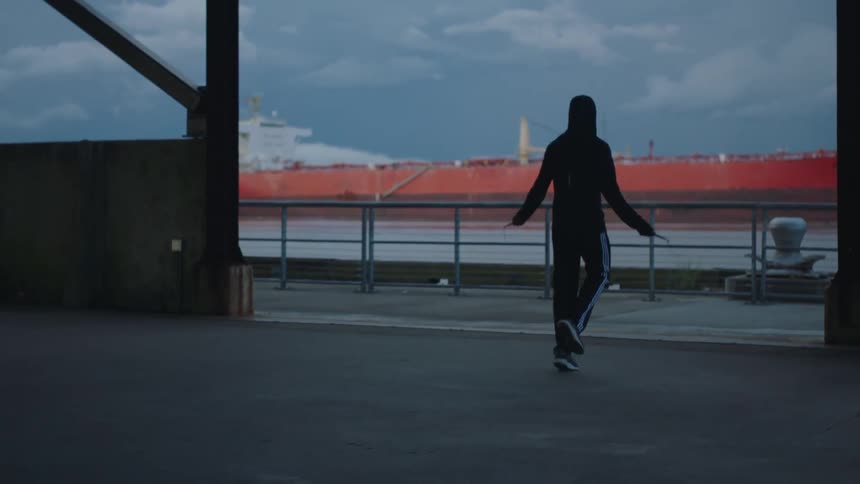 A woman jumps rope along the waterfront at dawn