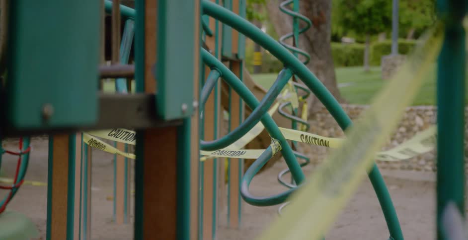 Closeup of caution tape covering playground equipment