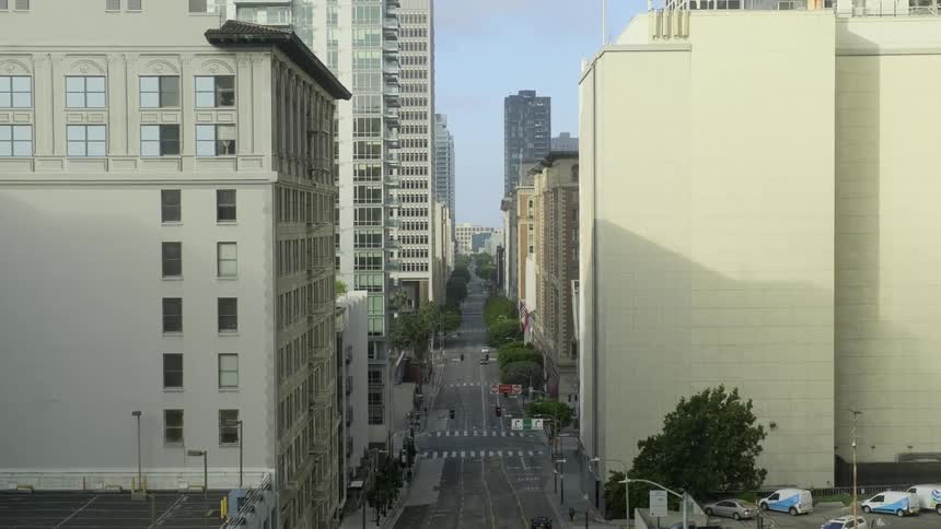 Cars parked and driving down a city street