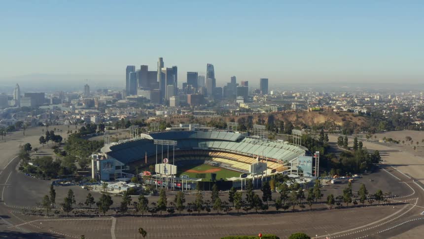 An aerial view of a downtown city and skyline is displayed