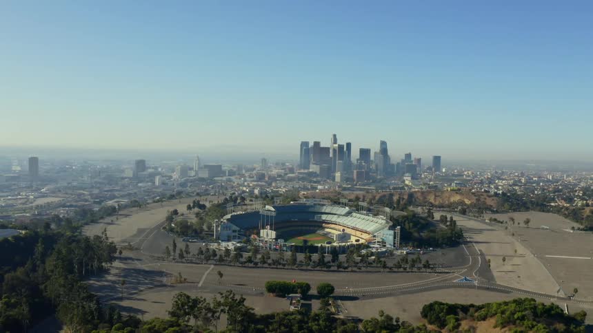 A sports arena with the city skyline in the distance