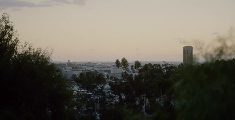 The slowly sets behind the city below