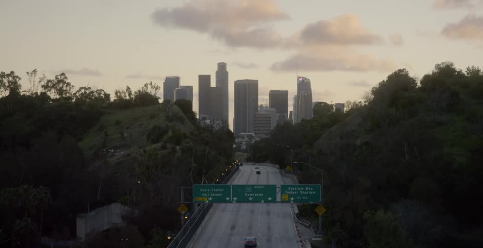 Traffic on the highway heads toward Los Angeles at sunrise