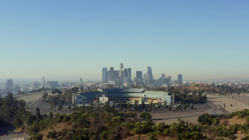 City skyline lies on the horizon behind an empty stadium