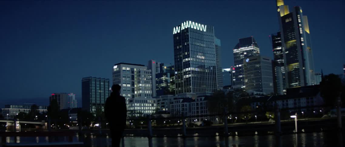 A man stands and looks at the city skyline