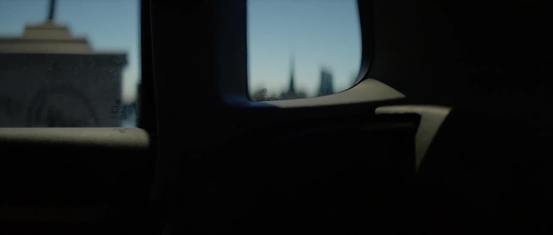The skyline view from the backseat of the car going over the bridge at dusk