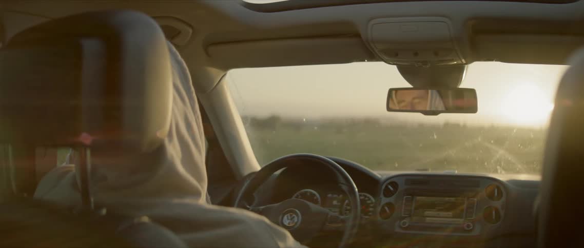 A man sleeps in a car
