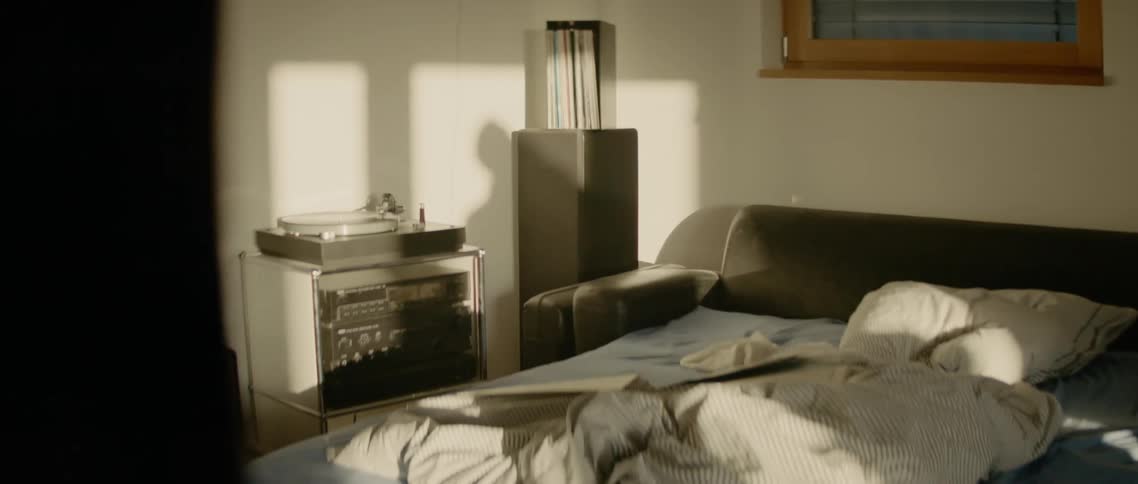 The shadow of a person dancing in their bedroom