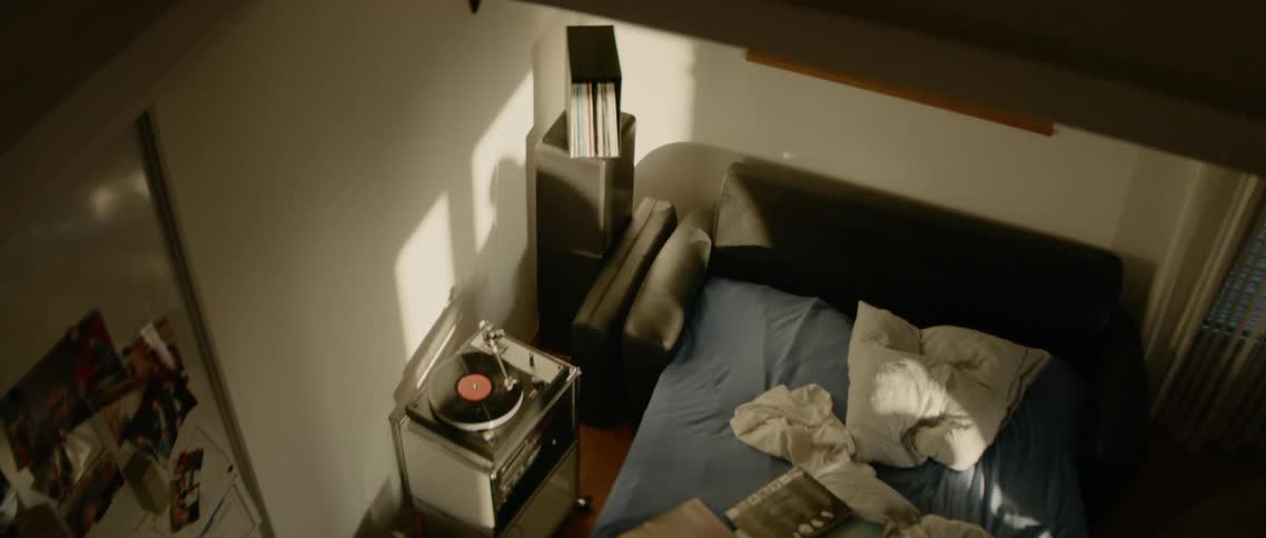 The shadow of a man on his bedroom wall