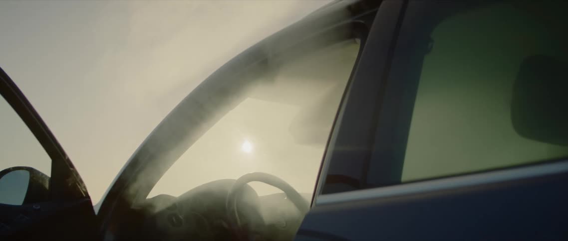 Smoke billows out of an empty car